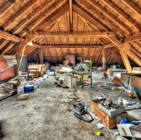 Overstuffed attic filled with various items and clutter, illustrating the benefits of professional property cleanout services in Carson City, NV.